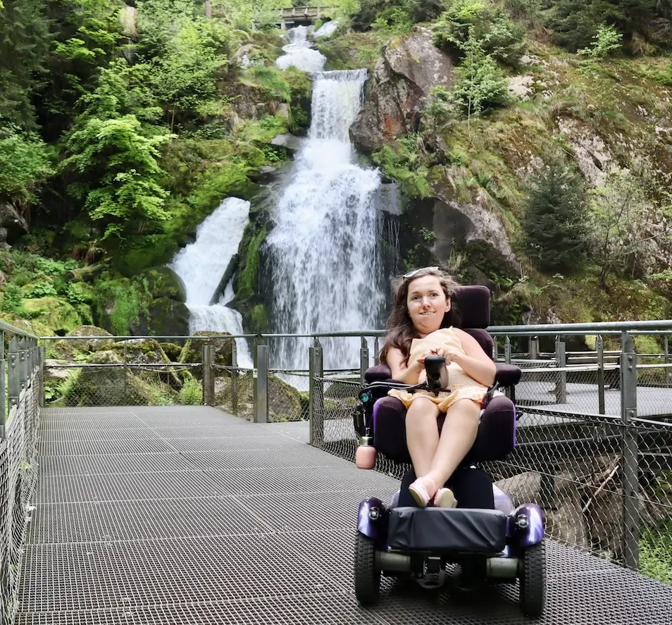 Karla, sitting in her Balder F380, in front of Triberg Falls in Germany 